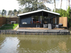 Modern chalet in a small park located right along a fishing pond